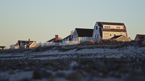 Wide-shot-of-a-row-of-beach-cottages-during-golden-hour