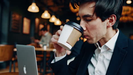 businessman working on laptop in a cafe