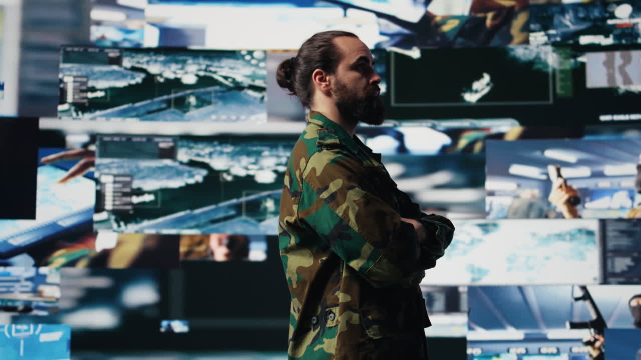 Young soldier working in command center with satellite surveillance