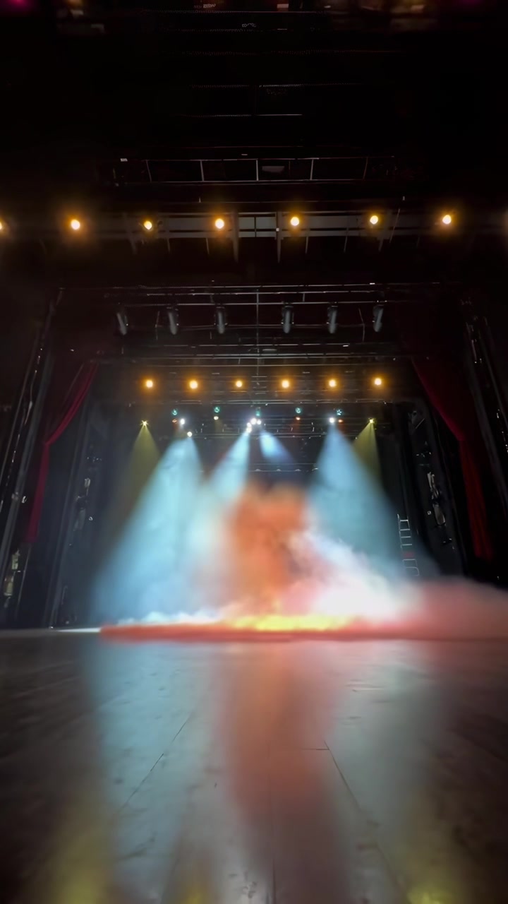 Empty Theater Stage with Dynamic Colorful Lighting and Smoke