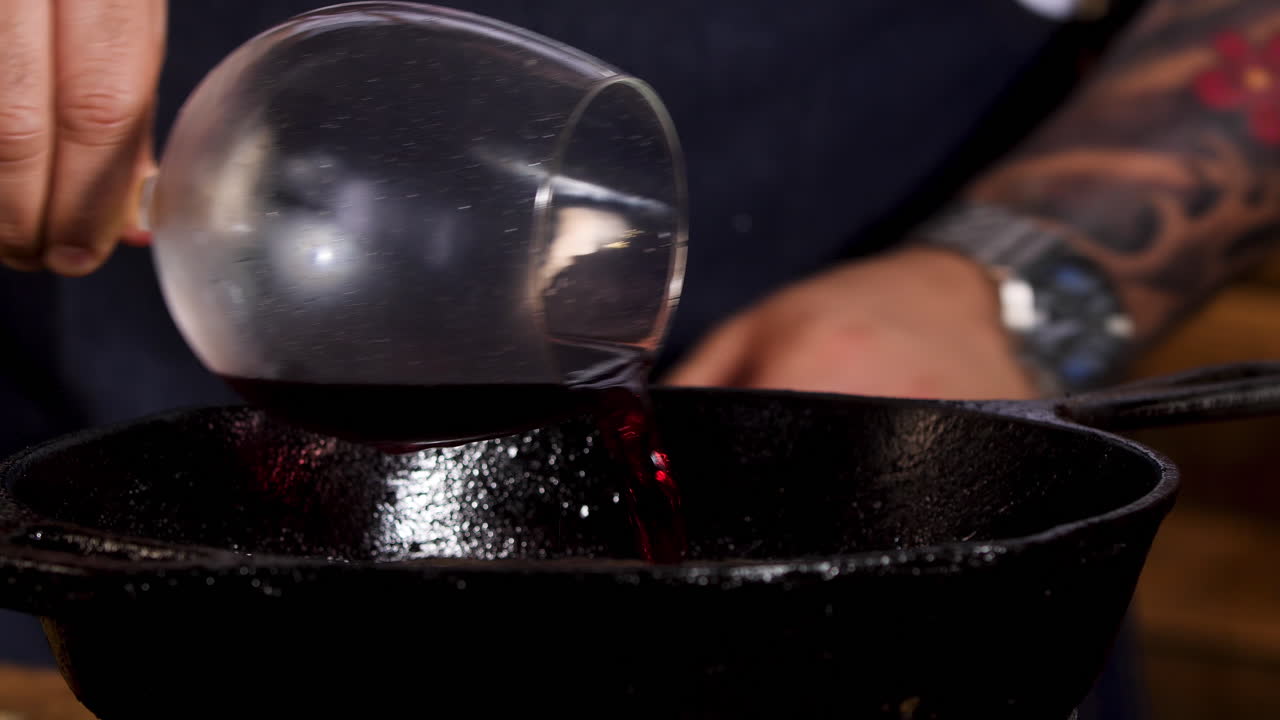 Pouring Red Wine into a Cast Iron Pan