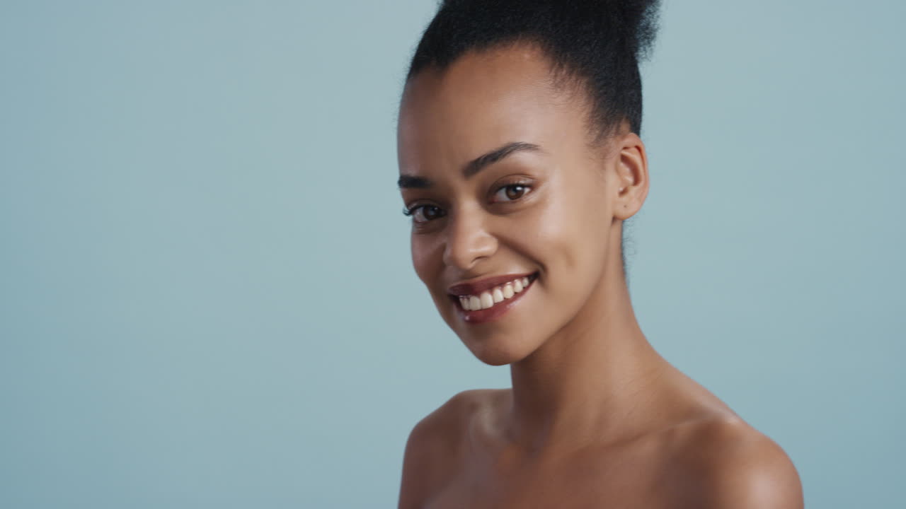 portrait beautiful young african american woman smooth healthy skin smiling looking confident gorgeous sensual skincare beauty on blue background