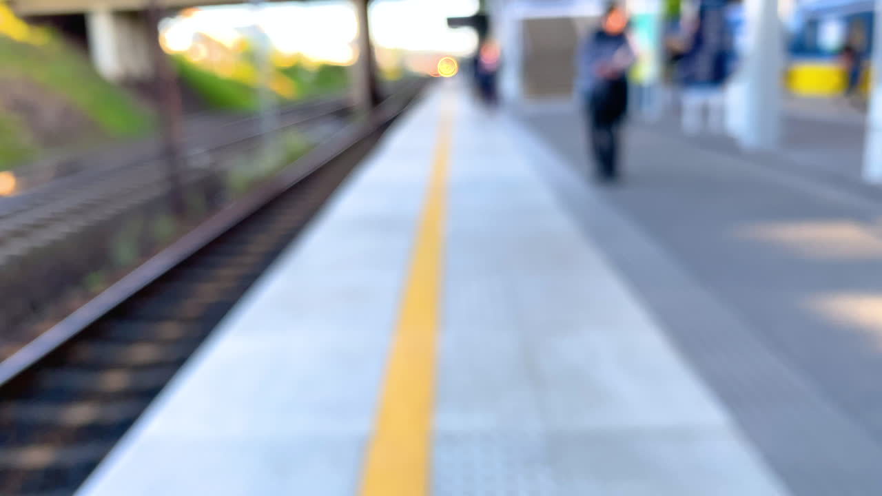 Passengers wait out of focus on quiet a Train Station Platform, defocused in Slow motion - High Frame Rate
