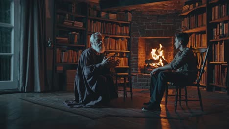 old man and boy in a library by the fireplace