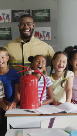 Video of happy african american teacher with class of diverse pupils during ohs lesson
