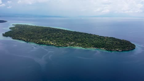 drone aerial video of deserted island paradise. travel vacation icon of tropical beach island menjangan with palm trees. turquoise crystal clear lagoon ocean water