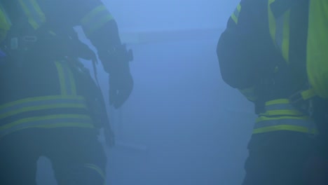 two-firefighter-in-a-room-full-of-smoke-searching-for-people