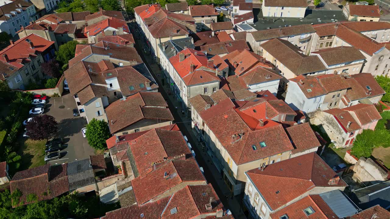 Overhead view of typically rooftops and narrow streets in Saint-Junien old town, Haute-Vienne, France. Drone forward