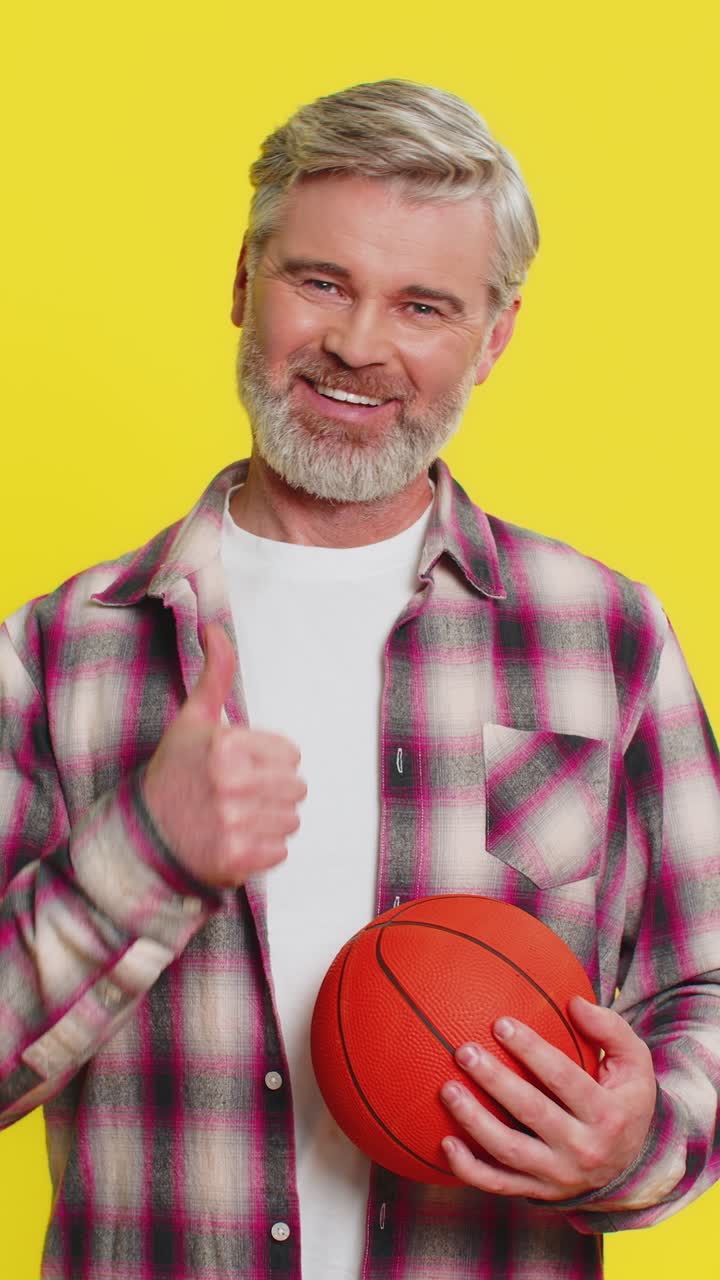 Mature man spinning basketball playful dribble exchange sporty game skill display energetic vibe