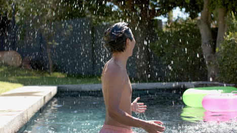 teenage asian boy enjoys a refreshing moment outdoors by the pool