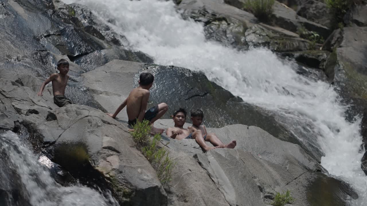 Children Playing at a Waterfall