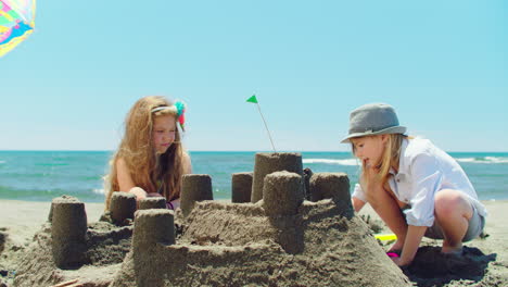 children building sandcastles on the beach