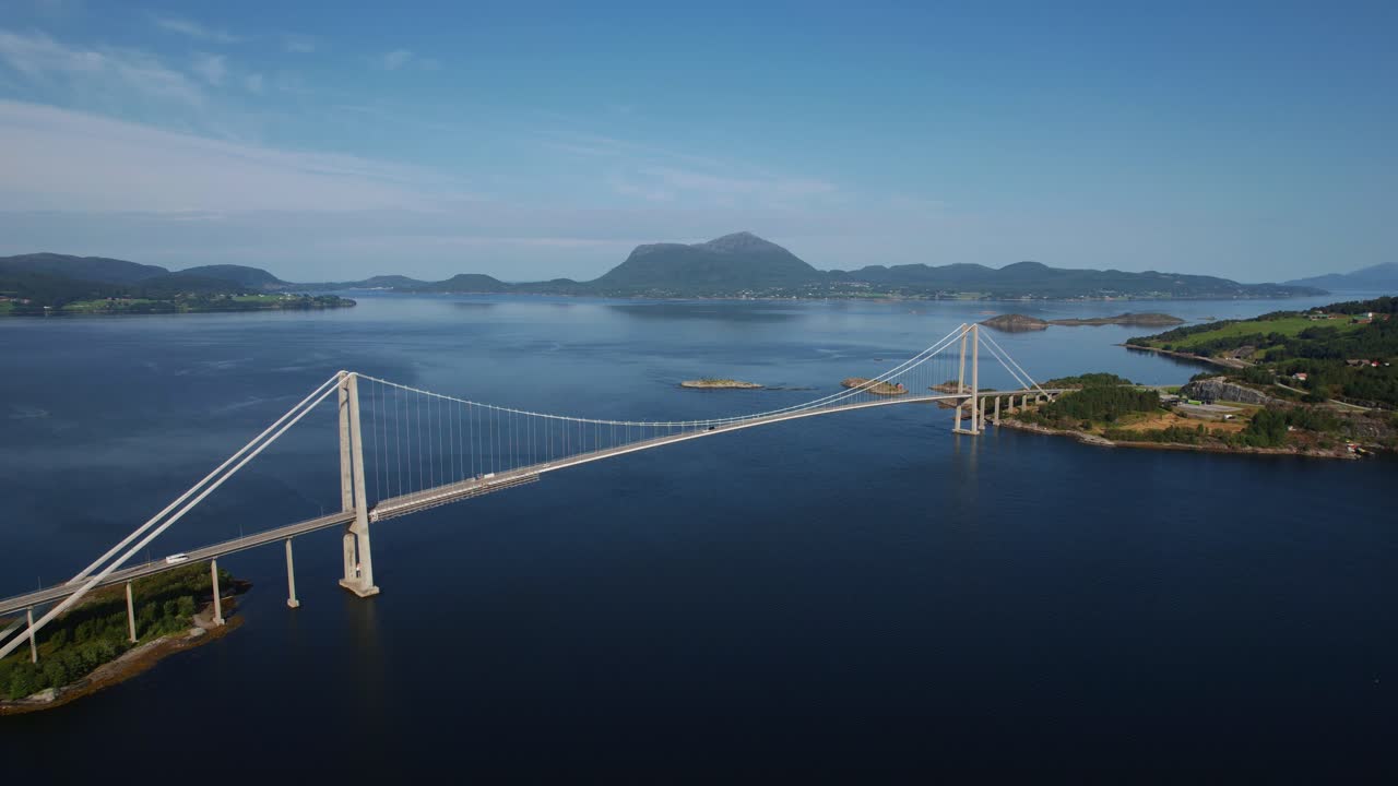 Stunning aerial showing a bridge of Norway's Atlantic Ocean Road amidst natural beauty, fjord and coast.