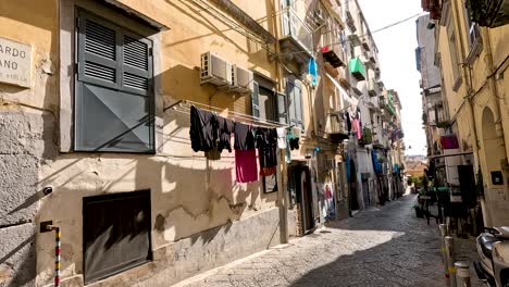 a narrow street with hanging laundry