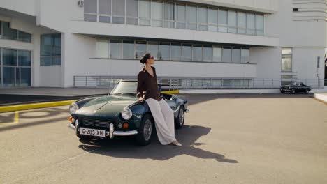 woman posing on a classic convertible car