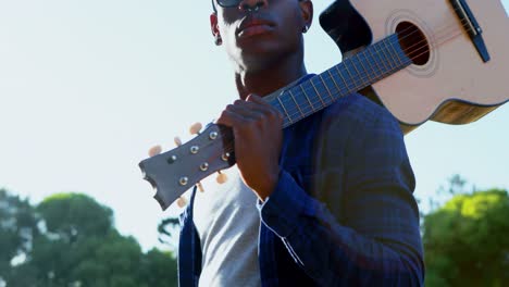 man holding guitar at festival 4k