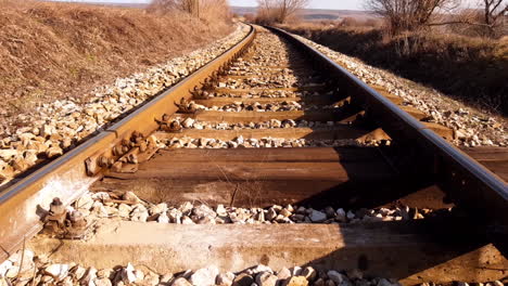 empty railroad tracks in hot and dry summer day