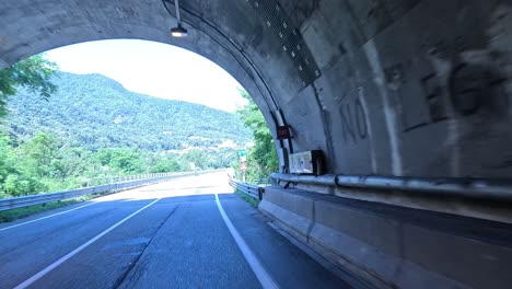 car exits tunnel into scenic mountain view