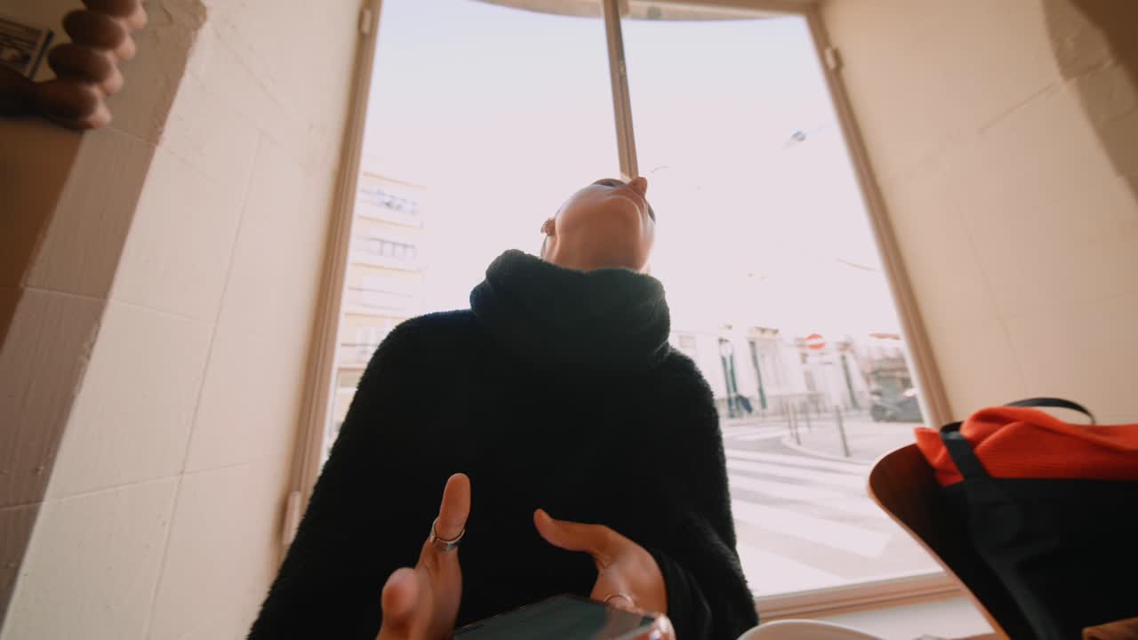 Woman looking at her phone indoors