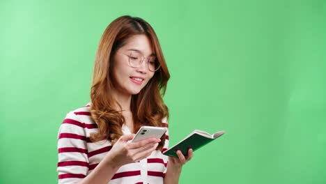 Asian-young-woman-book-ticket-with-her-passport-in-hands-in-studio-with-chroma-key-background