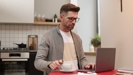 man drinking coffee and using laptop