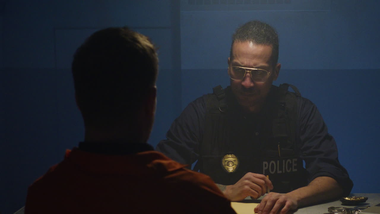 Tilt down to interrogation scene with cops