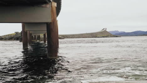 close up of old and rusty storseisundet bridge with atlantic ocean road in the background, norway