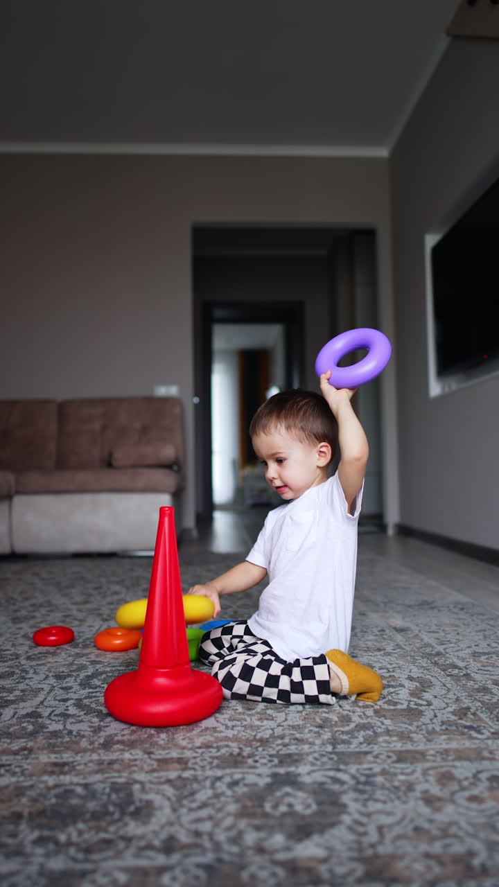 Baby boy playing and spend time funny. Funny child indoor activities. Vertical video.