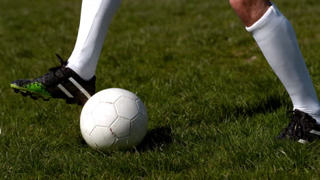 football player controlling the ball on grass