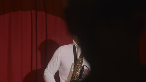 latin man playing sax during live music perfomance 1