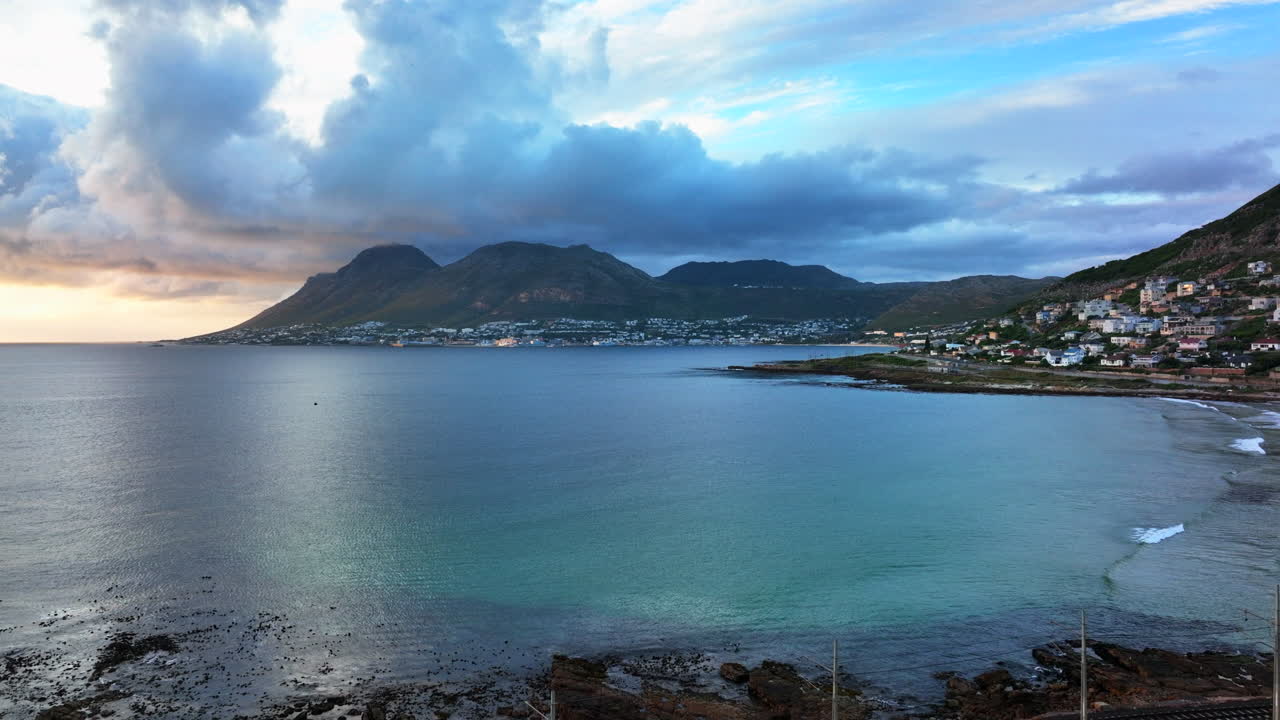 South African Simon's Town drone aerial cinematic Fish Hoek rugged boulder coastline small fishing town marina city stunning summer beach deep aqua blue ocean sea train tracks forward movement