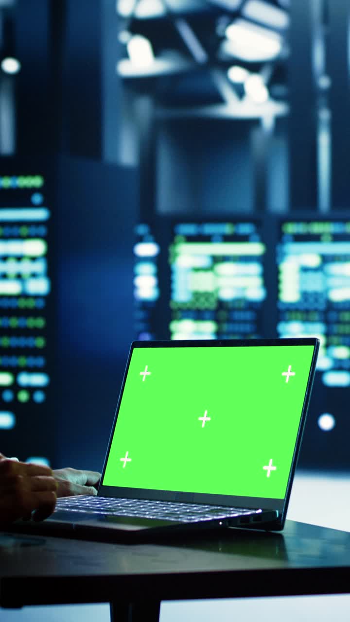 Vertical video Technician uses chroma key laptop for AI
