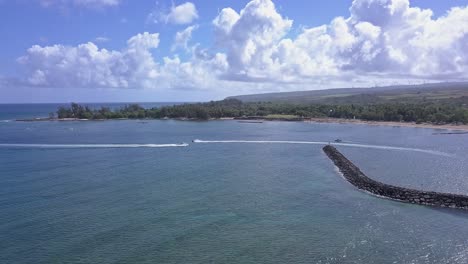 aerial view of two watercraft passing at waialua bay in hale'iwa oahu