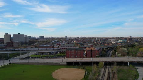 Urban-City-Neighborhood-With-Subway-Passing-Through-Aerial