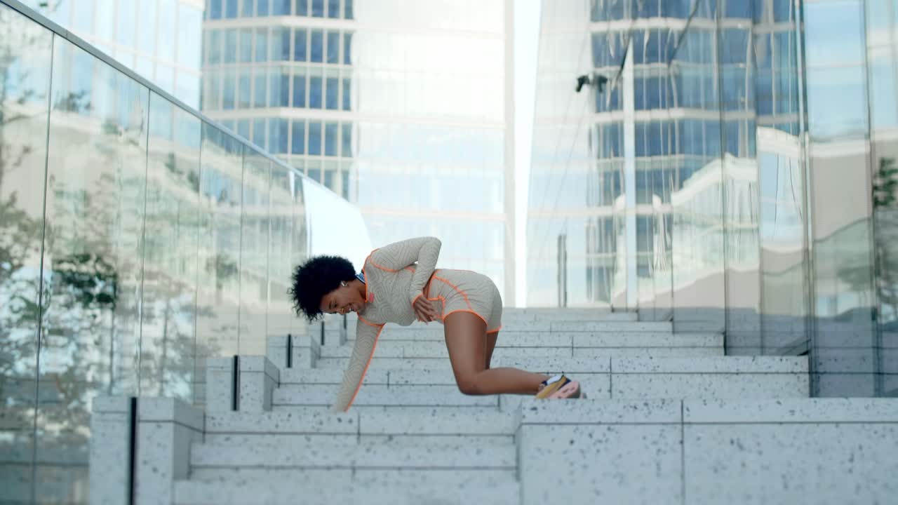 Woman Dancing on Steps in City