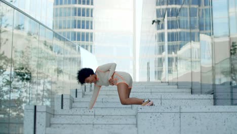 woman dancing on steps in city
