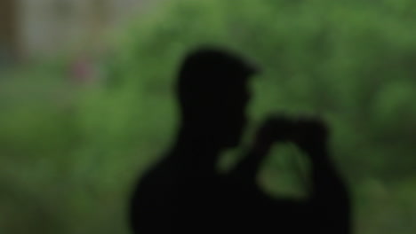 blurry image of person taking photo outdoors