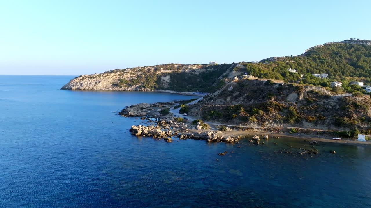 Aerial view flying along the rocky coastline of Rhodes, golden hour in Greece