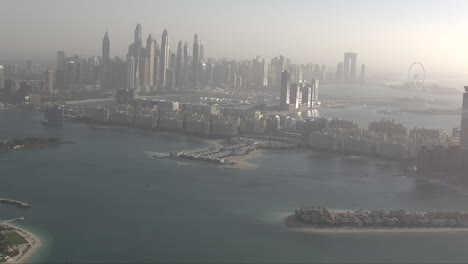 aerial establishing shot of downtown dubai with parts of atlantis coming into frame