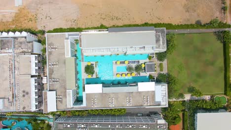aerial view of a rooftop pool complex with surrounding buildings