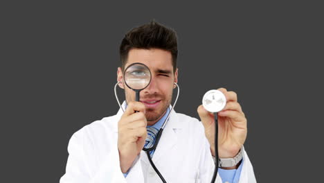 Young-doctor-looking-through-magnifying-glass