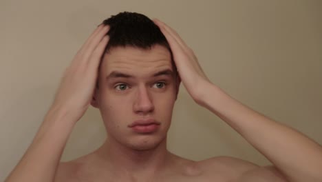 a young attractive person puts product in their short hair