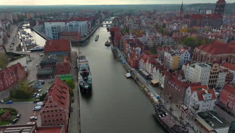 aerial shot of drone flying above motlawa river and old town of gdansk, poland