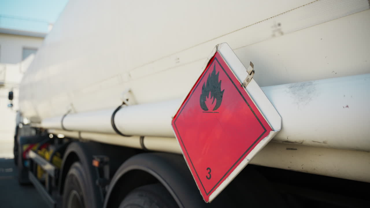 Simbol bahaya mudah terbakar pada truk tangki bahan bakar di SPBU saat mengisi bensin.
