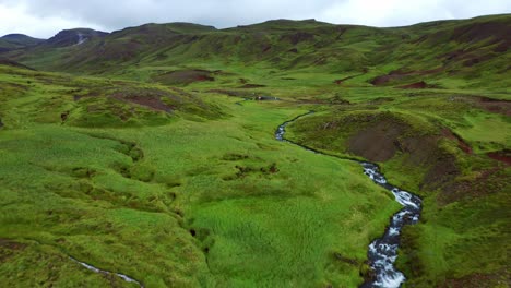 flyover flowing steam river in reykjadalur valley near reykjavik, south iceland