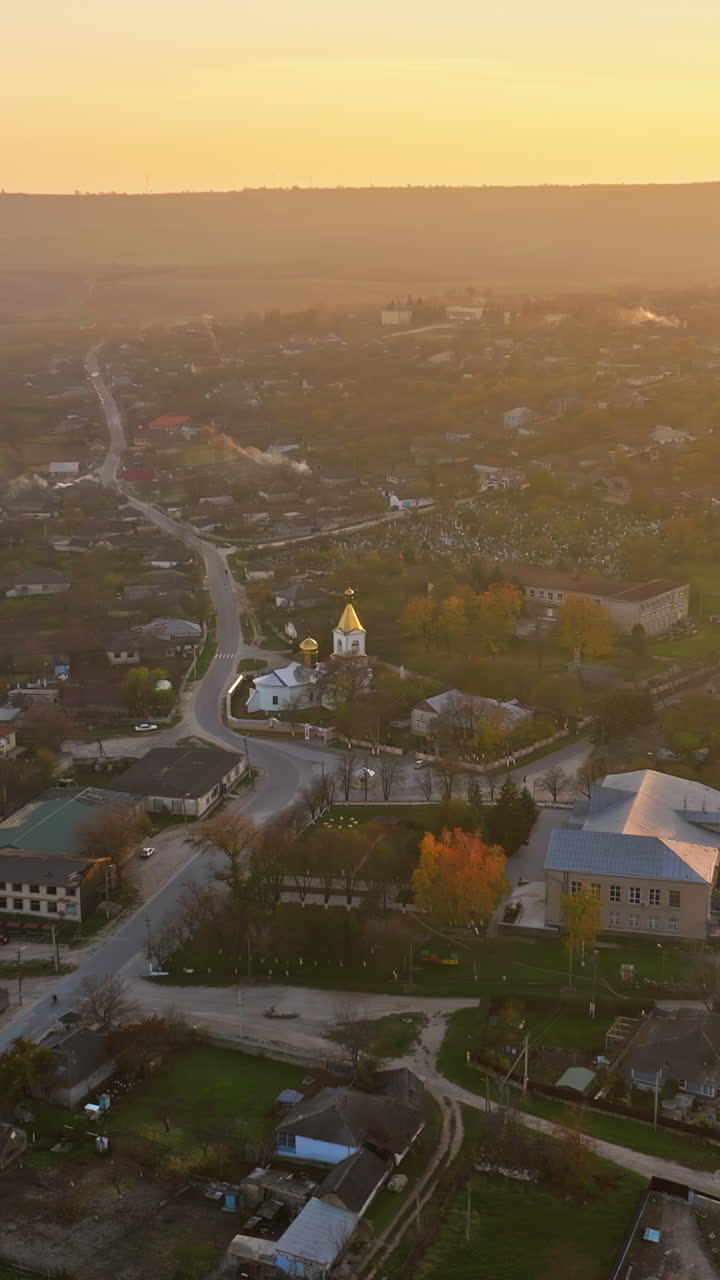 Aerial drone view of the houses in Orhei, Moldova at sunset. Vertical