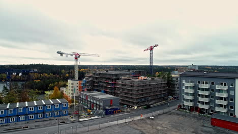 Establishing-drone-shot-of-construction-site-with-cranes,