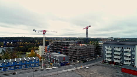 establishing drone shot of construction site with cranes,