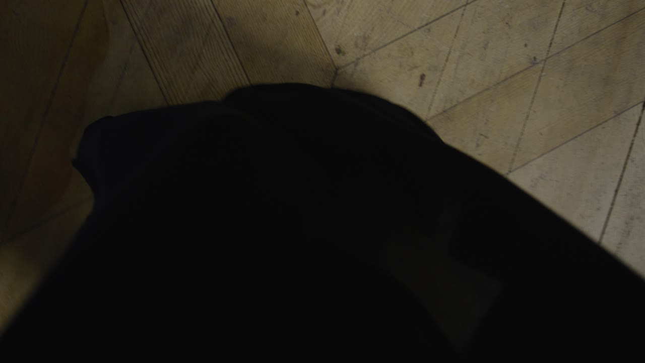 Graceful Balletic Female Dancer Black Dress Long Fluid Expressive Movement Barefoot Performance Wooden Floor Serene Poetic Calm Artistic Choreography Movement Study Elegant