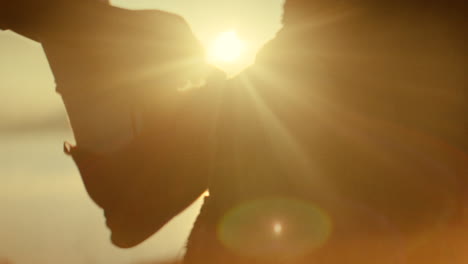 person tying shoe laces at sunrise